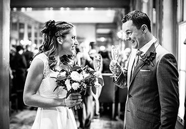 Bride and groom toasting each other at their wedding