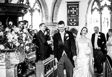 new husband and wife walking down the isle