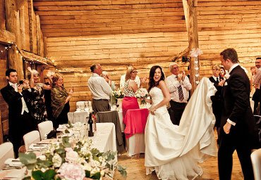 Bride and groom entering the reception venue photo